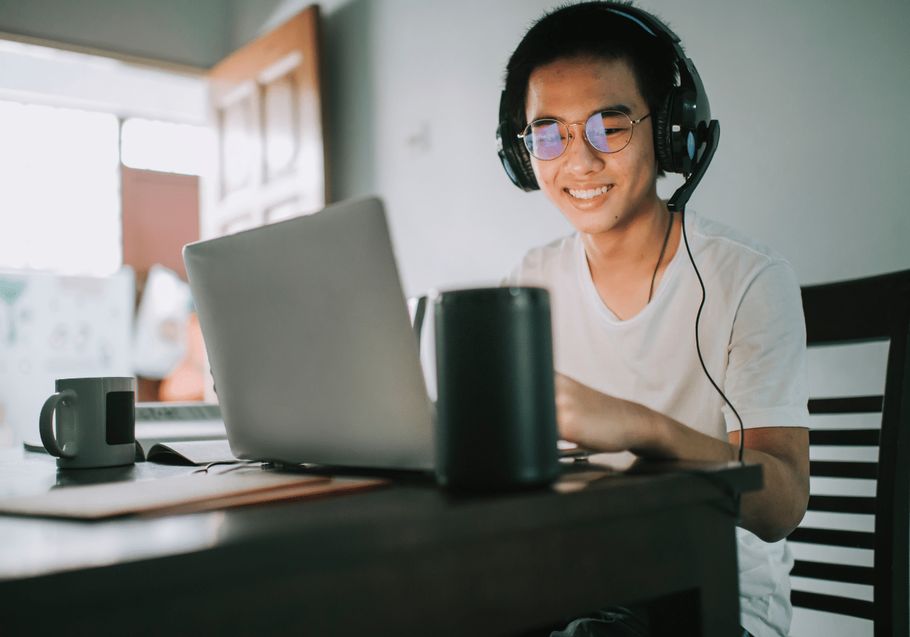 Professional man working from home, transitioning from a 9-5 corporate job to a flexible remote work career with Lumad Academy courses.